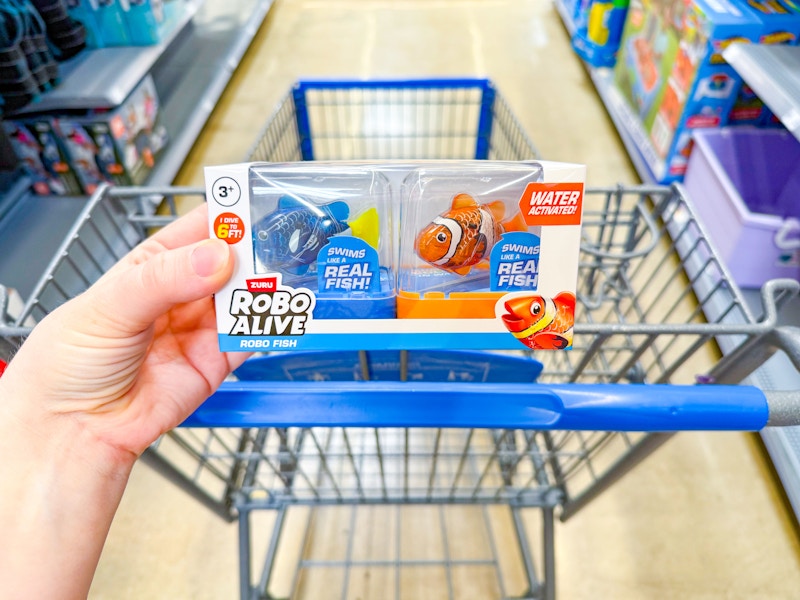 hand holding robo alive fish set over walmart cart