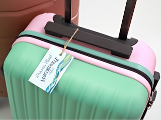 A suitcase with a tag that reads, "Dreams float. Margaritaville at Sea"