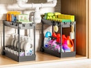 two organizers under a sink with cleaning supplies