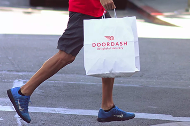 DoorDash delivery person carrying doordash bag
