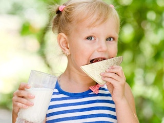 A little girl eating a sandwhich