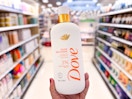 Holding a bottle of dove serum body wash in the middle of the aisle