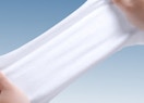 Hand stretching a disposable face towel