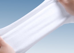 Hand stretching a disposable face towel
