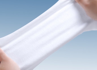 Hand stretching a disposable face towel