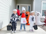 kids in costumes in front of door