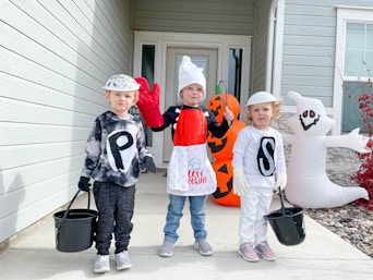 kids in costumes in front of door