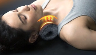a person laying on a heated neck stretcher