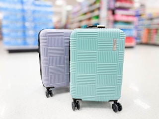 hardside spinner suitcases sitting in a target aisle