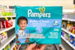 person holding a pack of baby wipes in an aisle