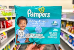 hand holding pampers baby-clean wipes in cvs