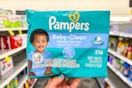 person holding a pack of baby wipes in an aisle