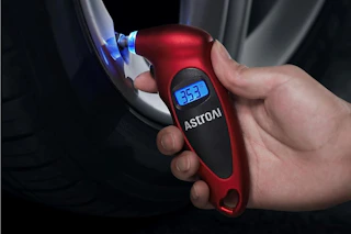 hand holding tire pressure gauge
