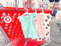 cloud island baby rompers hanging on a target cart