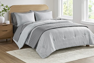 Lifestyle image of gray Mainstays 8-piece Bed in a Bag used on bed in bedroom