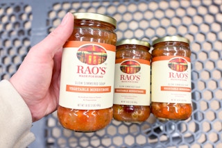 hand holding a jar of raos soup