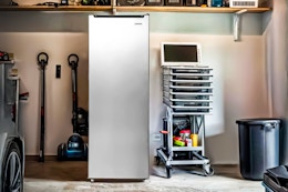 Lifestyle image of the Frigidaire 6.5 Cu. ft. Upright Freezer in garage setting