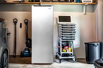 Lifestyle image of the Frigidaire 6.5 Cu. ft. Upright Freezer in garage setting