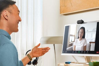 a man and woman talking on a logitech webcam