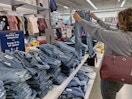 Woman holding up jeans in old navy