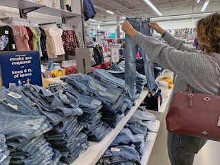 Woman holding up jeans in old navy