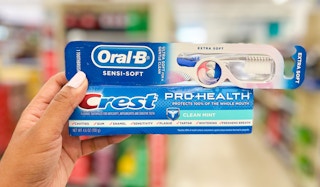 hand holding crest and oral-b