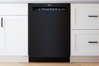 Lifestyle image of the Bosch 100 Series 24-in Front Control Built-in Dishwasher installed in a kitchen