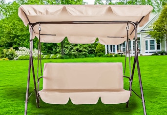 Lifestyle image of the beige GVDV Outdoor Porch Swing outdoors 