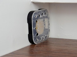 a roach bait station on a wall