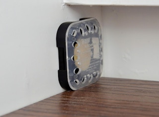 a roach bait station on a wall