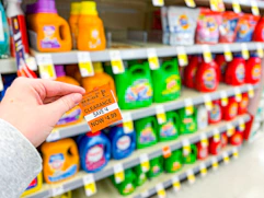 hand holding clearance tag in walgreens detergent aisle