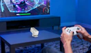 a mini projector on a table in a room in front of a TV