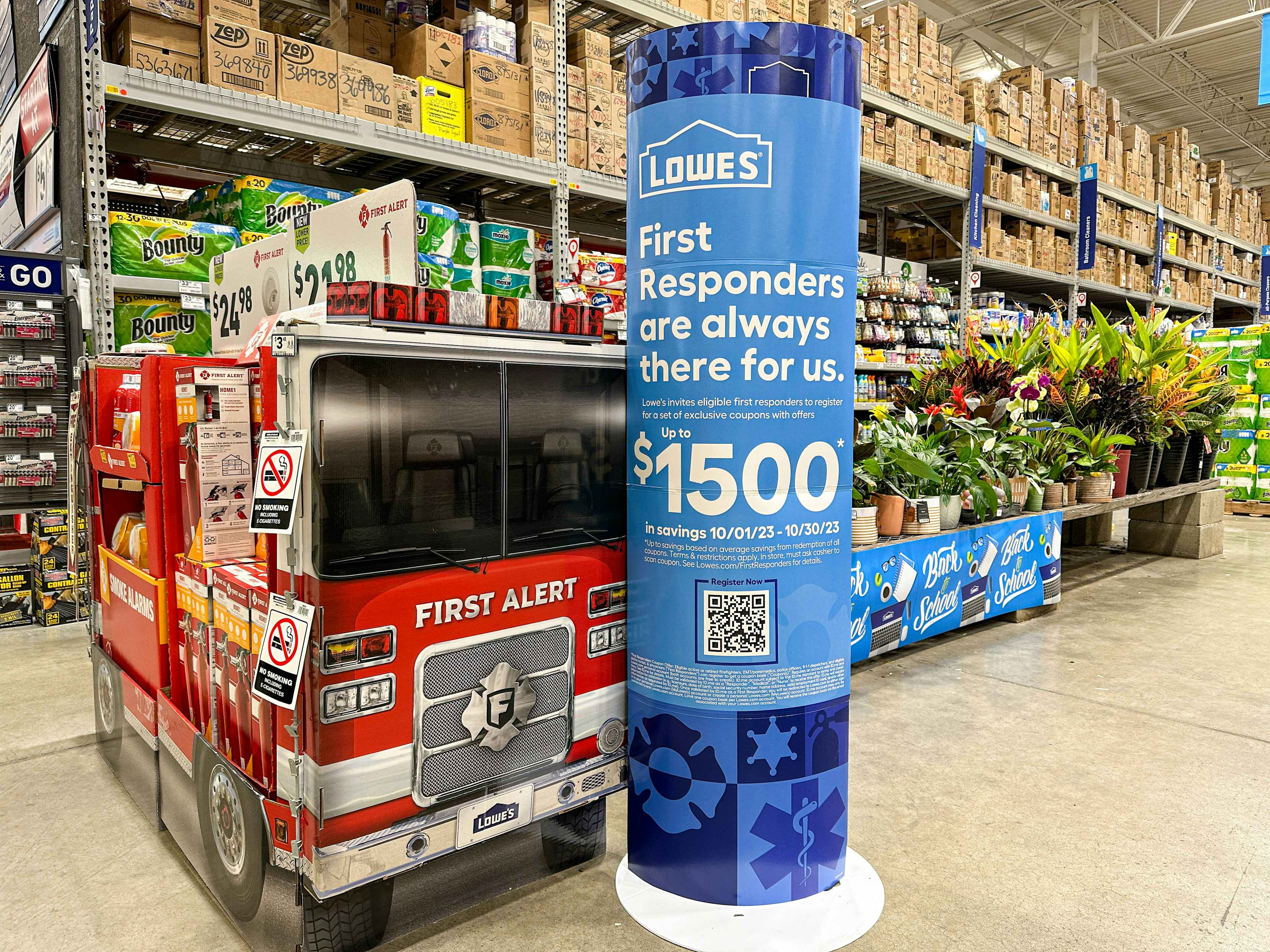 lowes first responder signage in store next to a cardboard fire truck display 