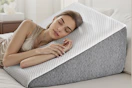 lifestyle image of a woman sleeping on a wedge pillow