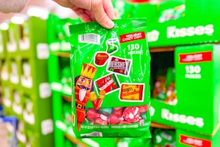 hand holding a bag of hersheys christmas candy