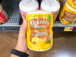 hand holding bottle of lemonade powder