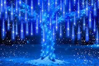 EAGWELL Meteor Shower Lights Outdoor Christmas Lights on a tree outside at night.