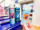 hand holding a degree whole body deodorant with two others on display at walmart