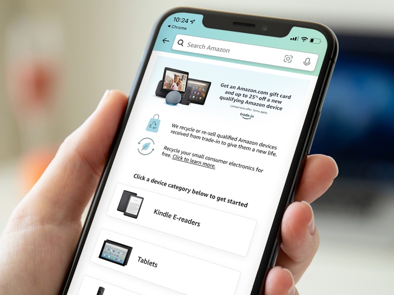 hand holding iPhone showing Amazon Device Trade-In on screen
