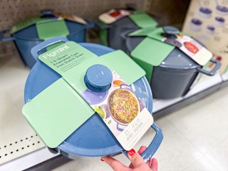 hand grabbing a figmint dutch oven off a target shelf
