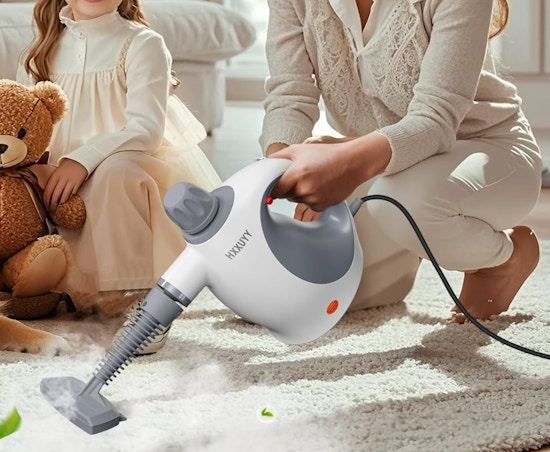 a person cleaning with a steam cleaner 
