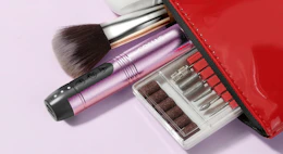 a nail drill and drill bit set in a red pouch