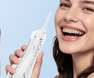 a woman holding a water flosser