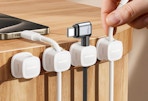 cords in magnetic clips on the side of a table 