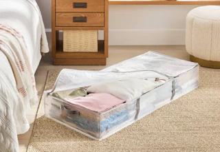 brightroom underbed storage bag sitting on a floor next to a bed