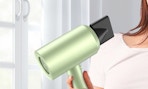 a hand holding a green hair dryer