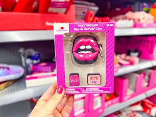 hand holding valentines day lips airpod case in walmart aisle