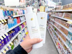 hand holding dove hair care in walgreens