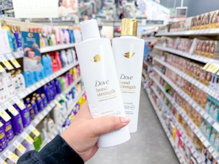 hand holding dove hair care in walgreens