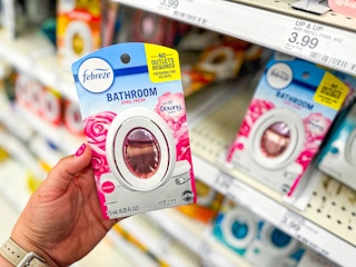 hand holding a febreze bathroom air freshener at target